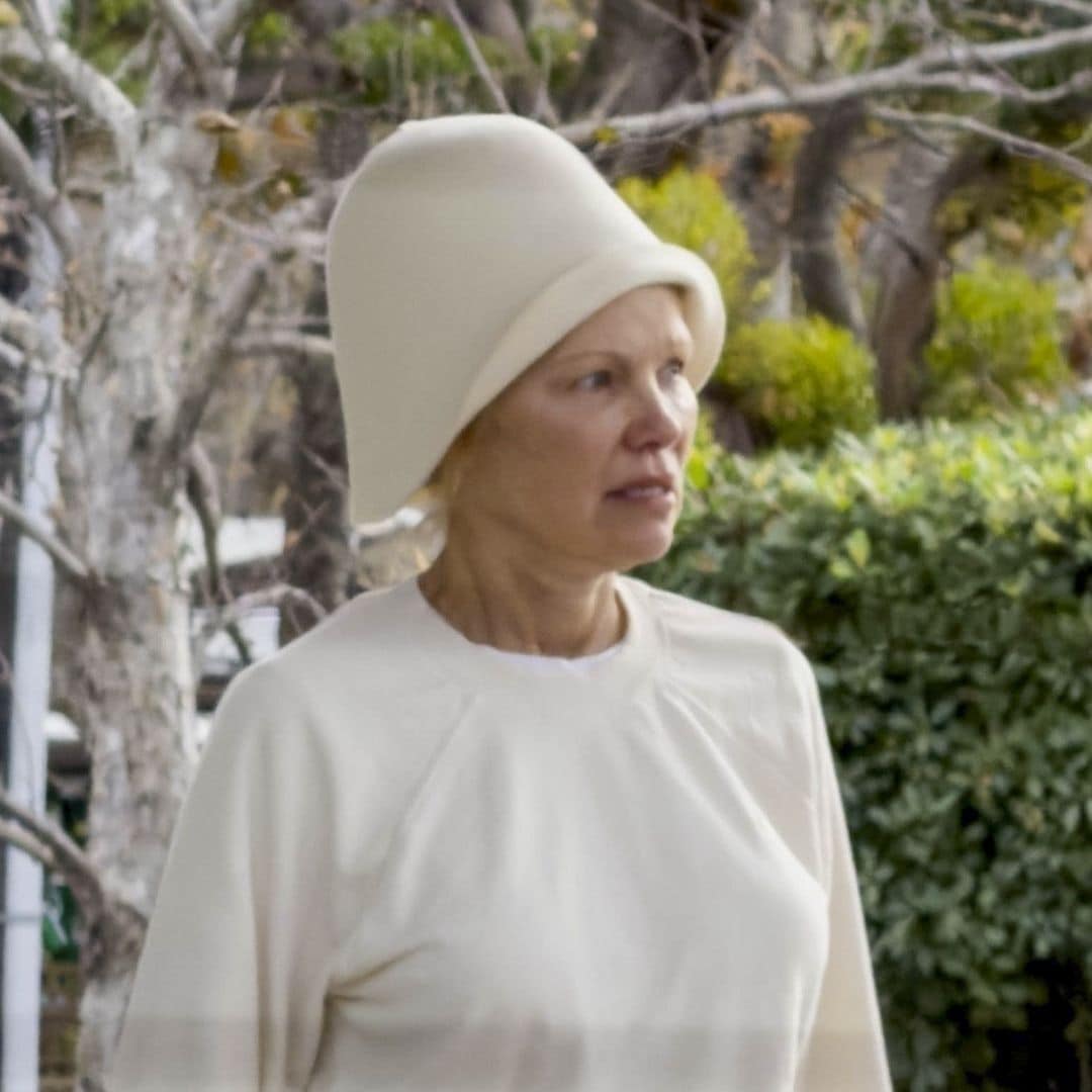Pamela Anderson looks unrecognizable as she goes makeup-free in all-white look and bold hat