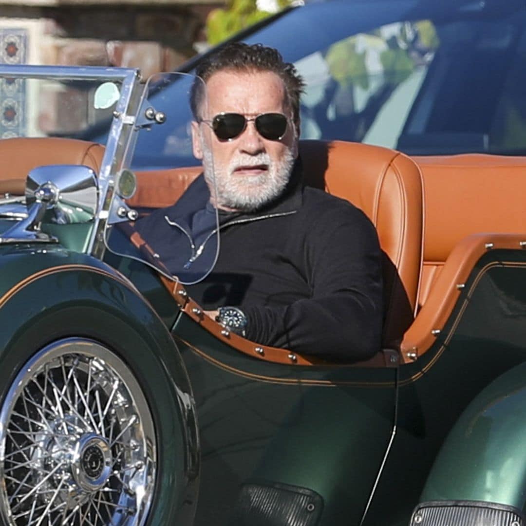 Arnold Schwarzenegger beams while cruising in a classic Mercedes convertible