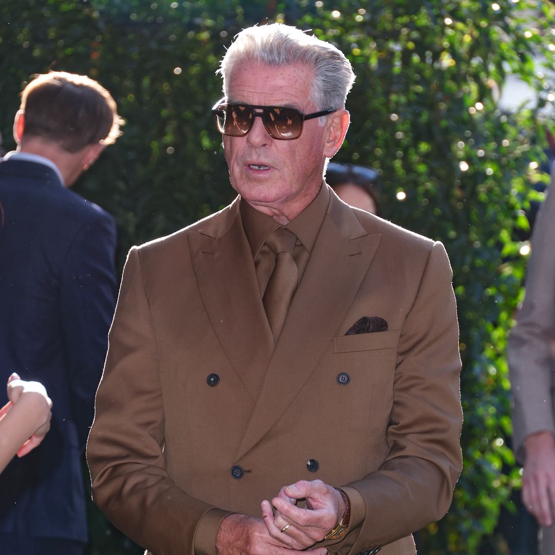 Pierce Brosnan proudly poses with his son Dylan, 28, and his granddaughter Isabella, 26