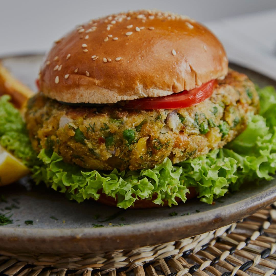 Healthy vegan hamburger on a handmade ceramic plate, made of zucchini, green pea, seasoning, herbs and spices, close up