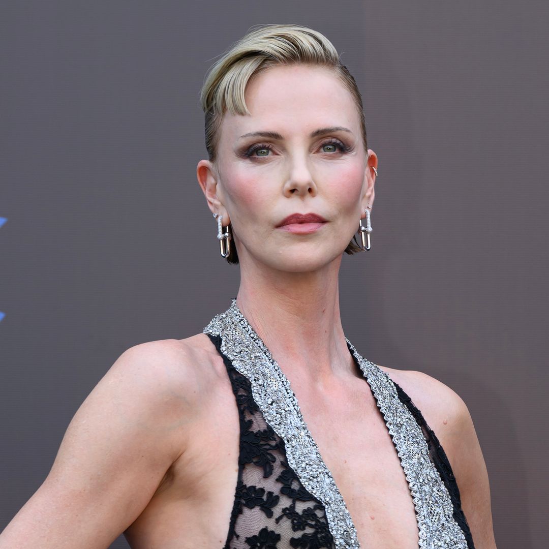 Charlize Theron unveils dramatic new look with edgy baby bangs and daring sheer gown