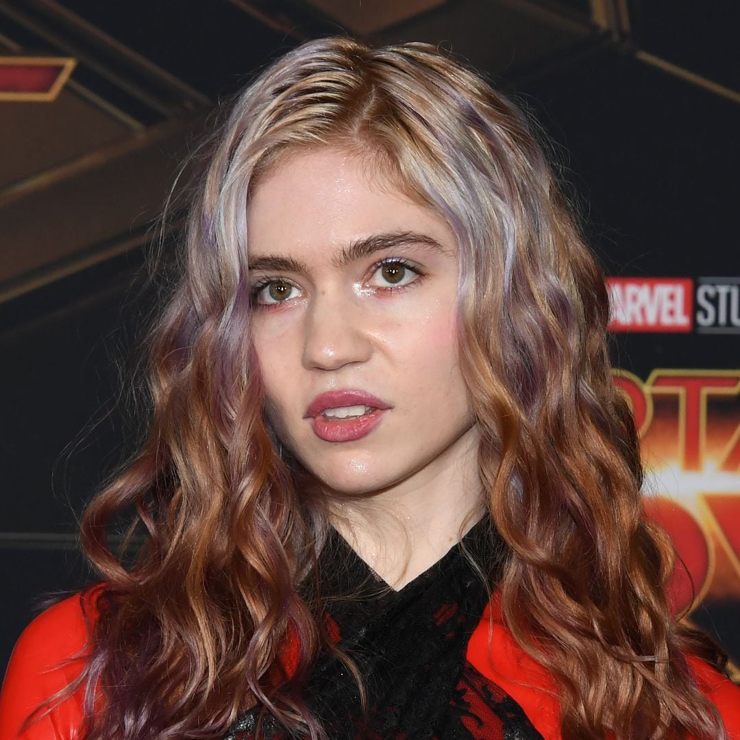 Grimes debuts a new face tattoo but is met with brutal feedback comparing it to fungus