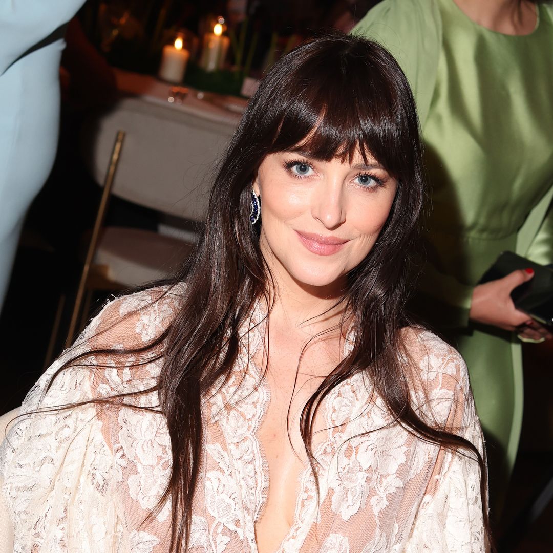 Dakota Johnson steps out in lace micro shorts and sheer tights during Paris Couture Week