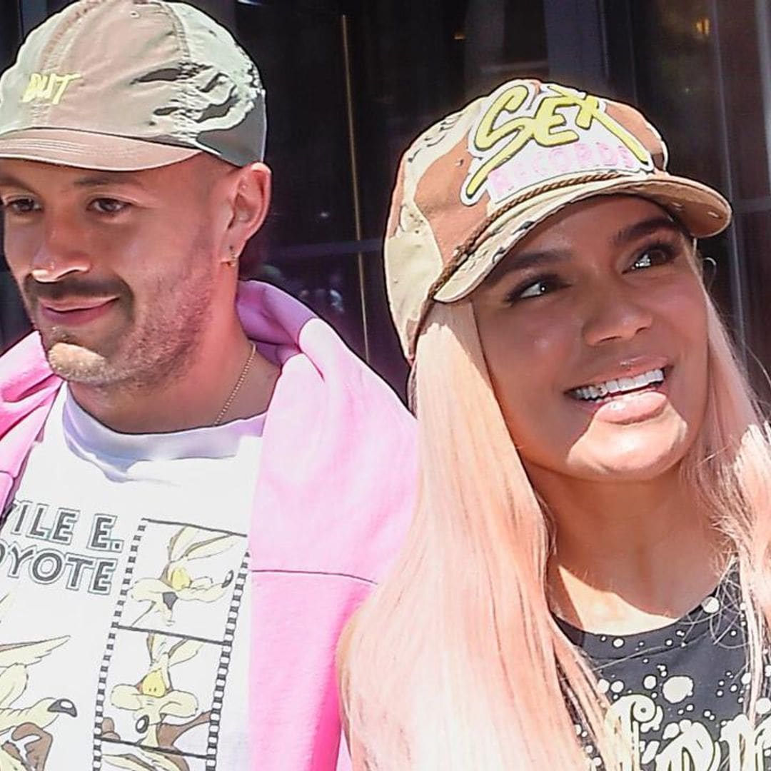Karol G and Feid are all smiles holding hands in NYC during romantic outing