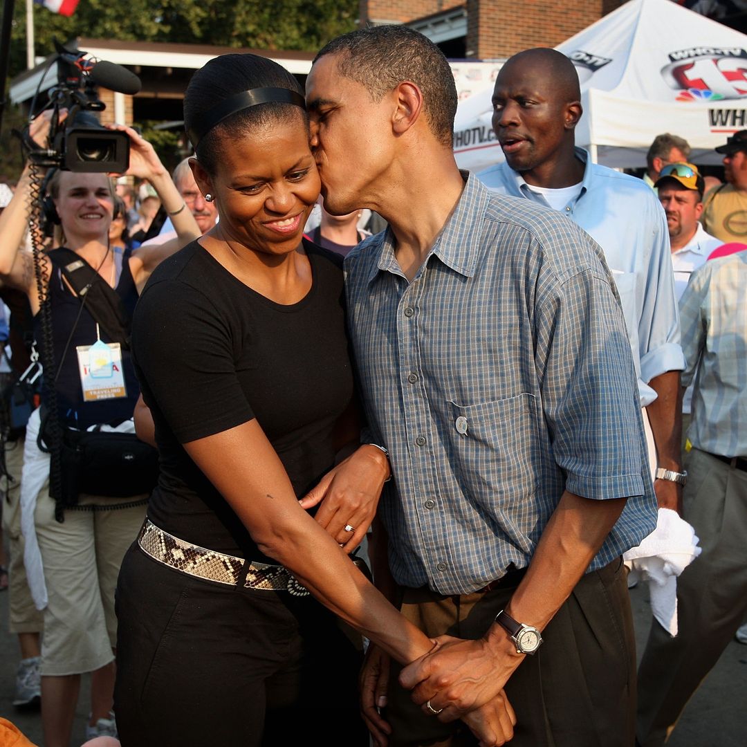 DES MOINES, IA - AUGUST 16:  Democratic Presidential Candidate Senator Barack Obama (D-IL) gives his wife Michelle a playful kiss as they tour the Iowa State Fair August 16, 2007 in Des Moines, Iowa. The fair runs until August 19th and is expected to draw about 1 million people. John Edwards also made a campaign stop at the fair today.  (Photo by Scott Olson/Getty Images) 