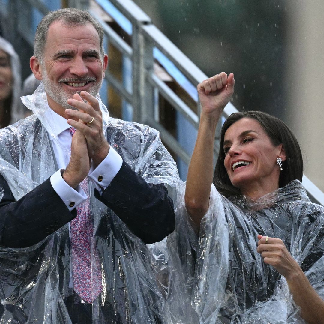 Queen Letizia and King Felipe keep dry in ponchos at Paris Olympics Opening Ceremony