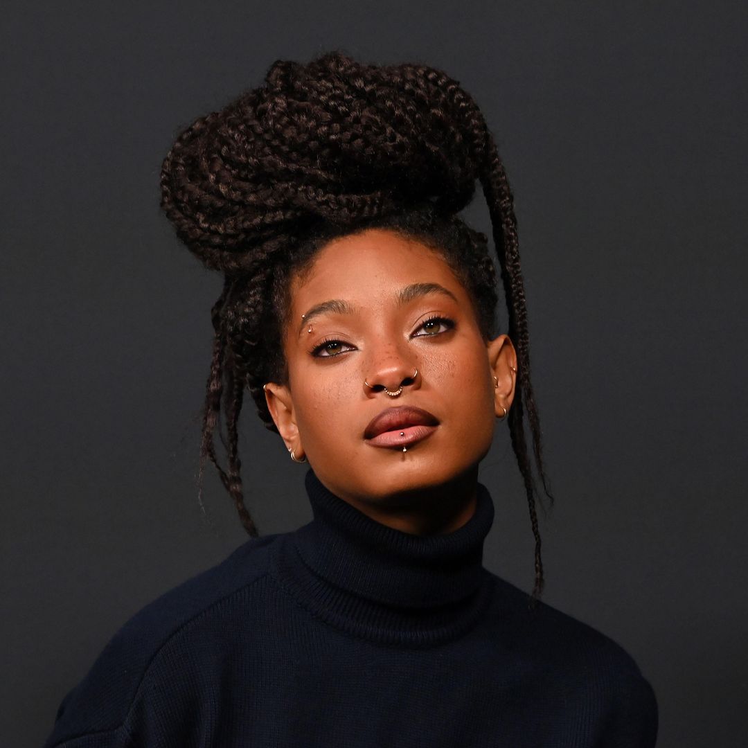 Willow Smith turns heads in emerald green dress and purple thigh-highs for major music announcement
