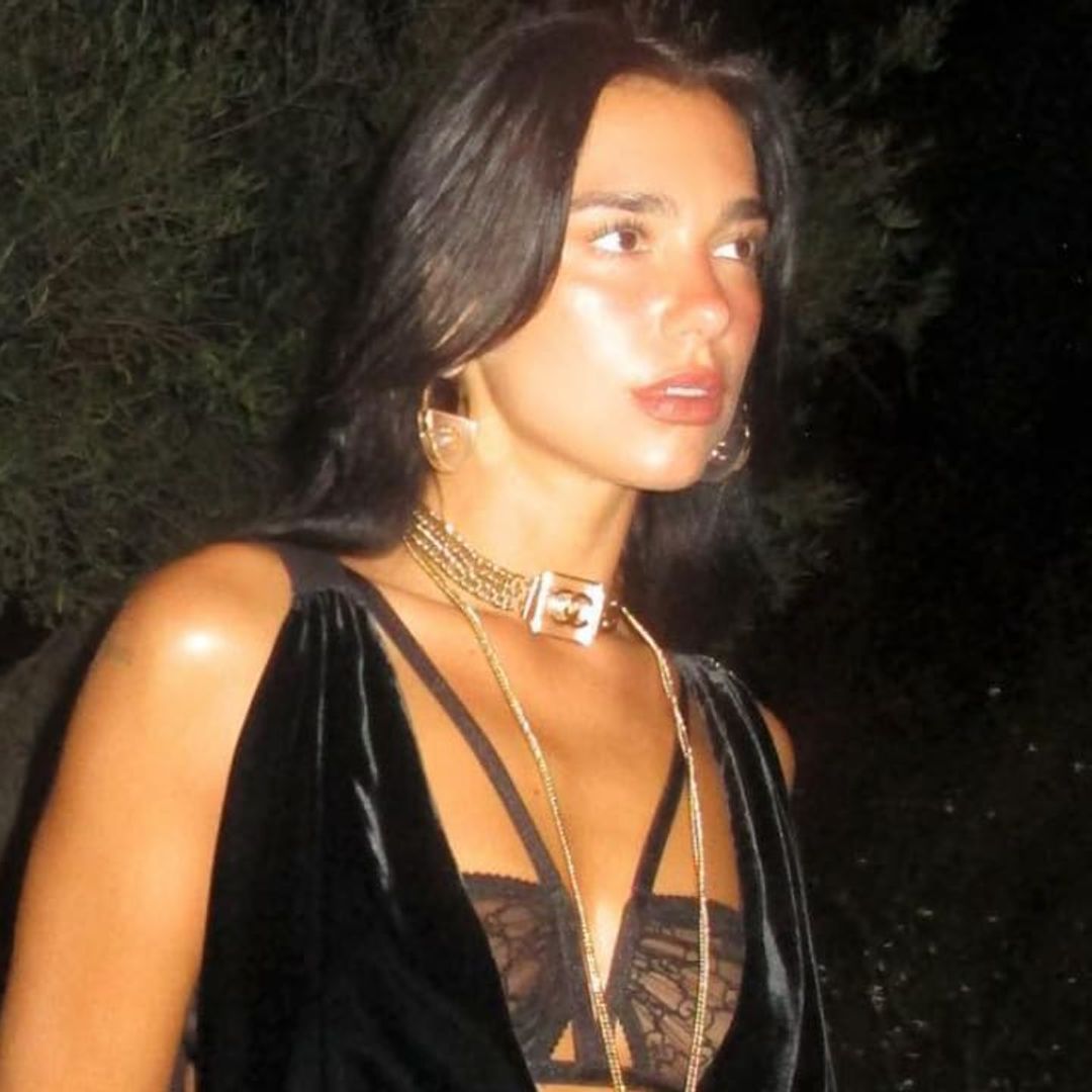 Dua Lipa’s Labor Day outfit includes white see-through dress and thigh-high boots