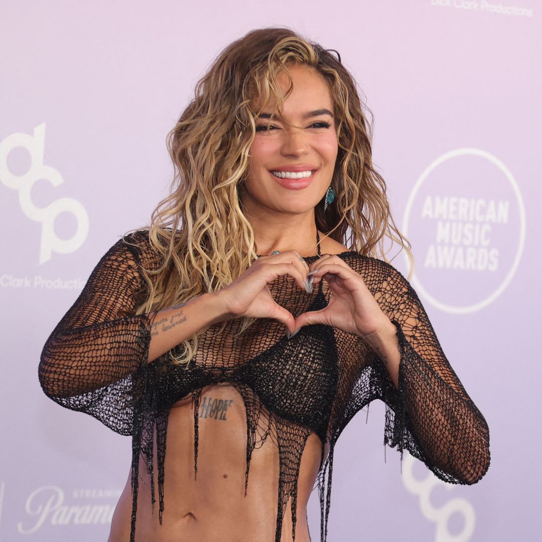 Karol G takes a break from her Tropicoqueta aesthetic in a goth look at the 2026 AMAs