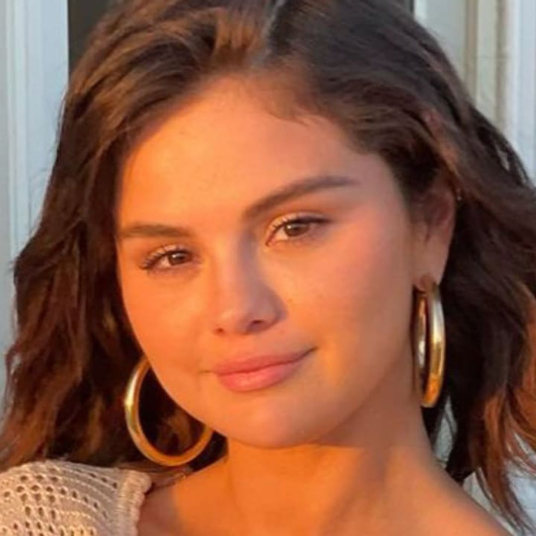 Selena Gomez pairs pink bikini with denim overalls for the perfect summer outfit