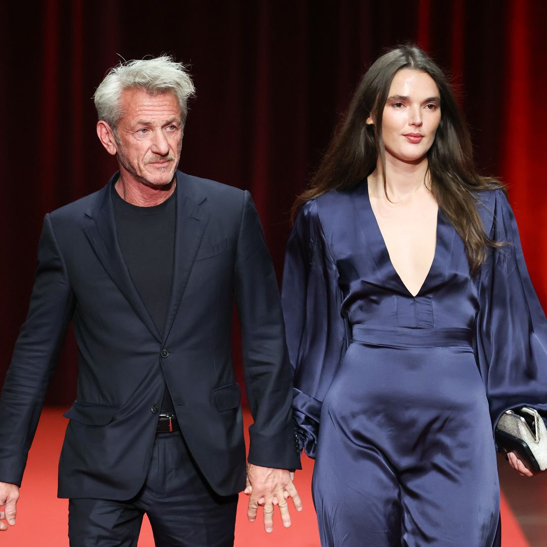 Sean Penn (65) walks red carpet with girlfriend, model Valeria Nicov (30), and he appears uncomfortable and distant