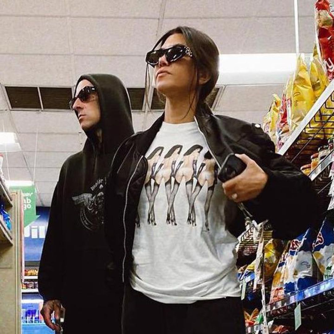 Kourtney Kardashian poses with Travis Barker at a truck stop while on tour
