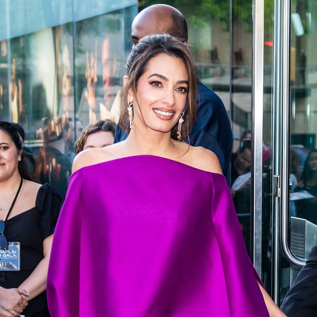 Amal Clooney puts a chic spin on the mini dress, showing off her legs in a bold purple look and gold pumps