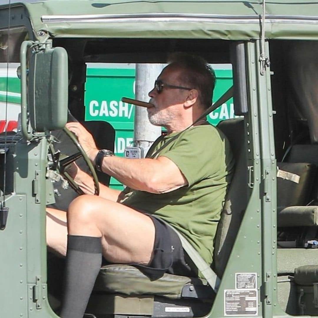 Arnold Schwarzenegger goes for a smoke and a drive on his huge Hummer
