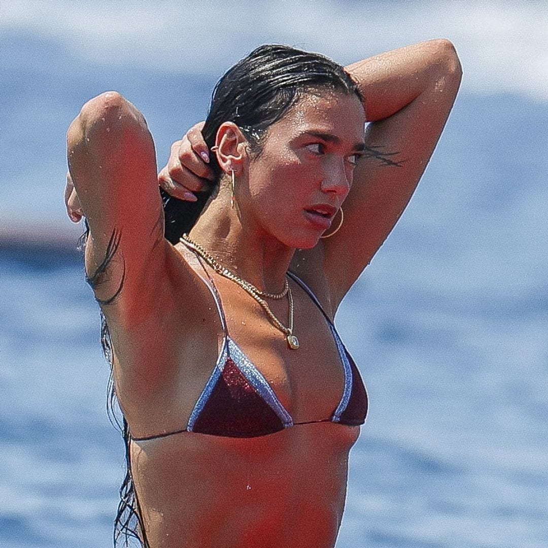Dua Lipa does yoga on a surfboard in a bikini while celebrating her birthday in Ibiza with Callum Turner