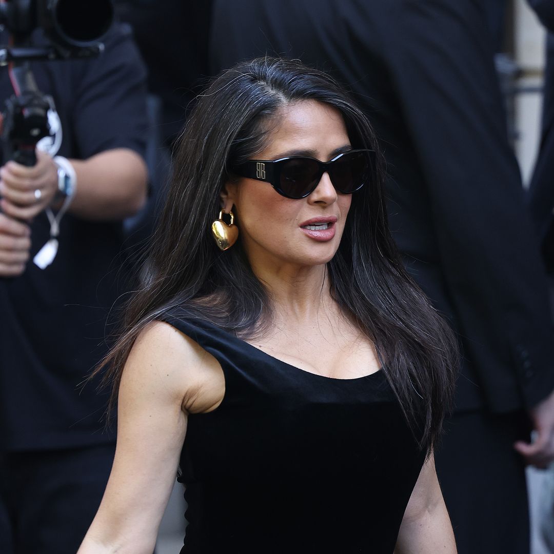 Salma Hayek posed in figure-hugging velvet dress and rocked her natural gray hair at Paris Fashion Week