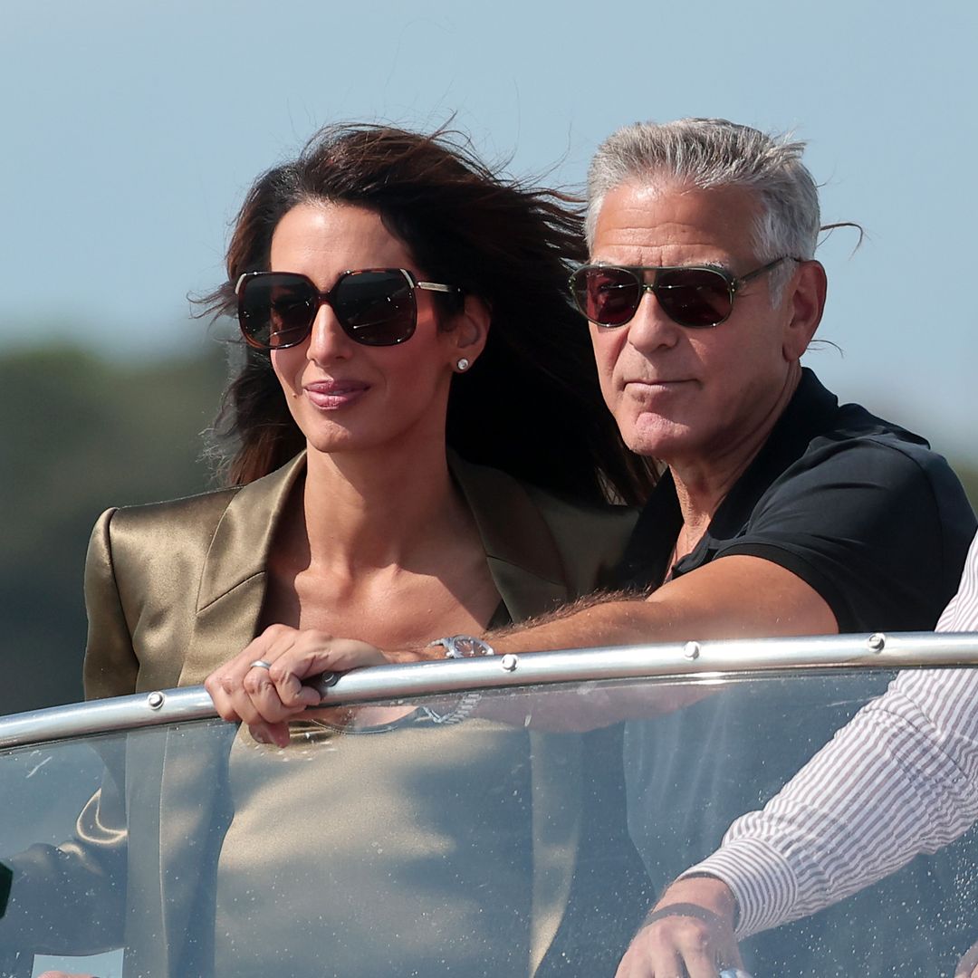 George and Amal Clooney look straight out of a romantic film as they arrive in Venice
