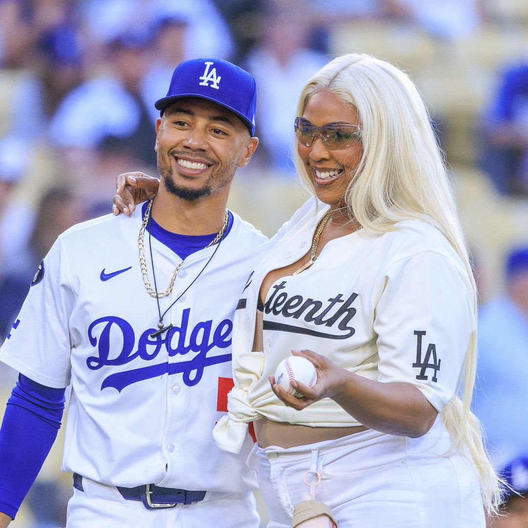 Lizzo throws the first pitch at a baseball game wearing heels and a Labubu keychain