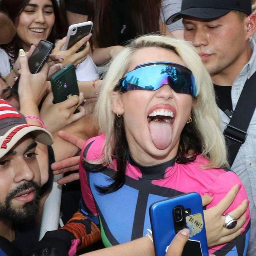 Miley Cyrus poses and takes selfies with fans as hundreds filled the streets in Argentina for her arrival