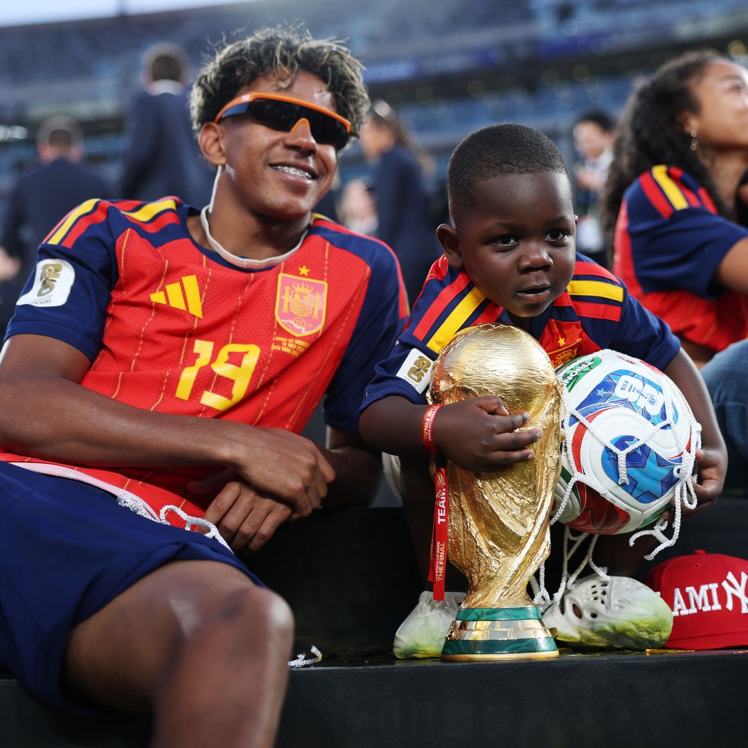 Lamine Yamal #19 of Spain celebrates with his little brother Keyne and the FIFA World Cup Winner's Trophy after the team's victory following the FIFA World Cup 2026 Final match between Spain and Argentina
