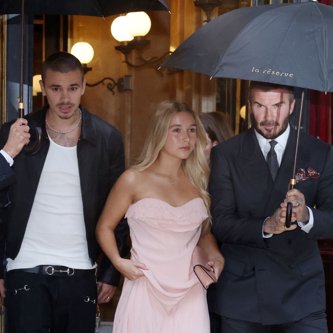 David Beckham praises Victoria as the family supports her at Paris Fashion Week - minus Brooklyn