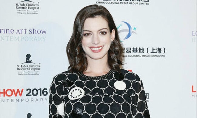 Anne Hathaway shows off her growing baby bump
