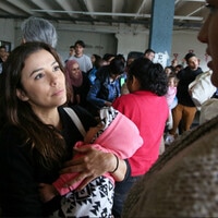 Emotional Eva Longoria cradles baby as she hears mother's story at Tijuana Border Crossing