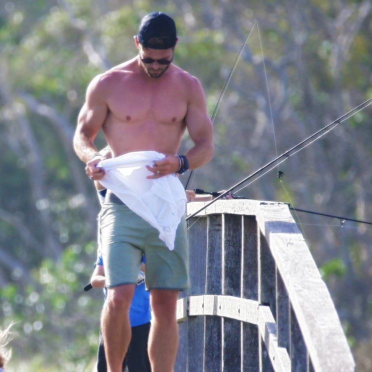 Chris Hemsworth shows off his incredible physique on family fishing trip