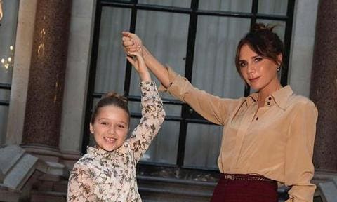 Victoria Beckham with daughter Harper Seven holding hands