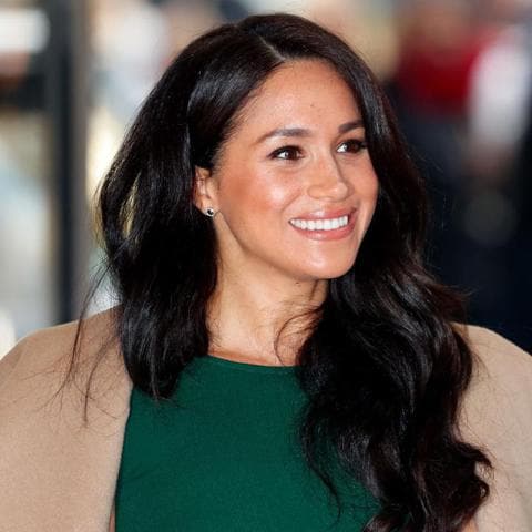 Meghan Markle with her hair down, neutral makeup, and radiant skin