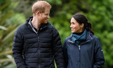 Prince Harry and Meghan Markle walk in forest park
