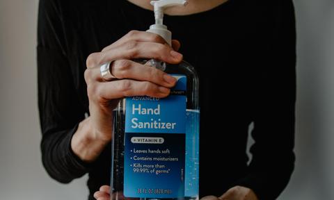 woman holding hand sanitizer