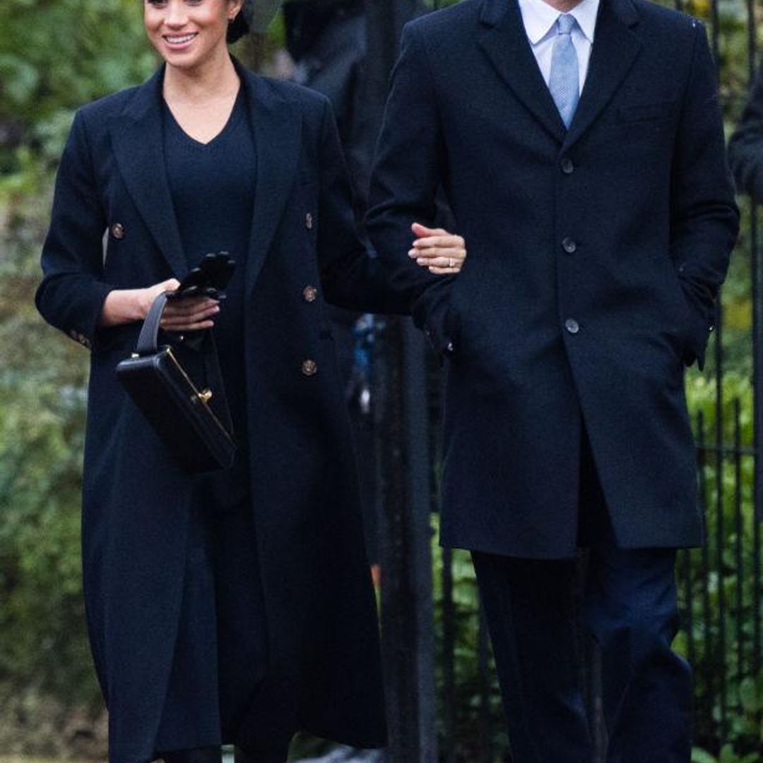 Meghan wore a navy blue Victoria Beckham dress and coat with knee-high boots