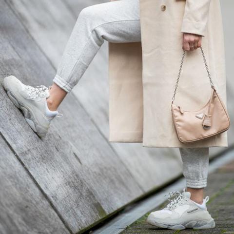 Inga Brauer is seen wearing grey jogger pants H&M, creme white coat &other stories, Triple S sneaker Balenciaga, beige bag Prada mulit-pochette reedition 2005