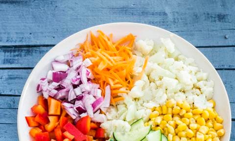 Chopped raw vegetables and sweetcorn in a bowl