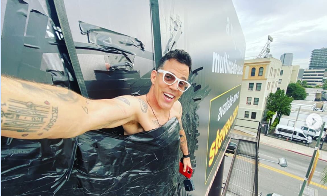Jackass star Steve-O duct tapes himself to a billboard wearing just a diaper