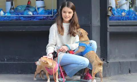 Suri Cruise seen playing with her puppies while out and about in New York City