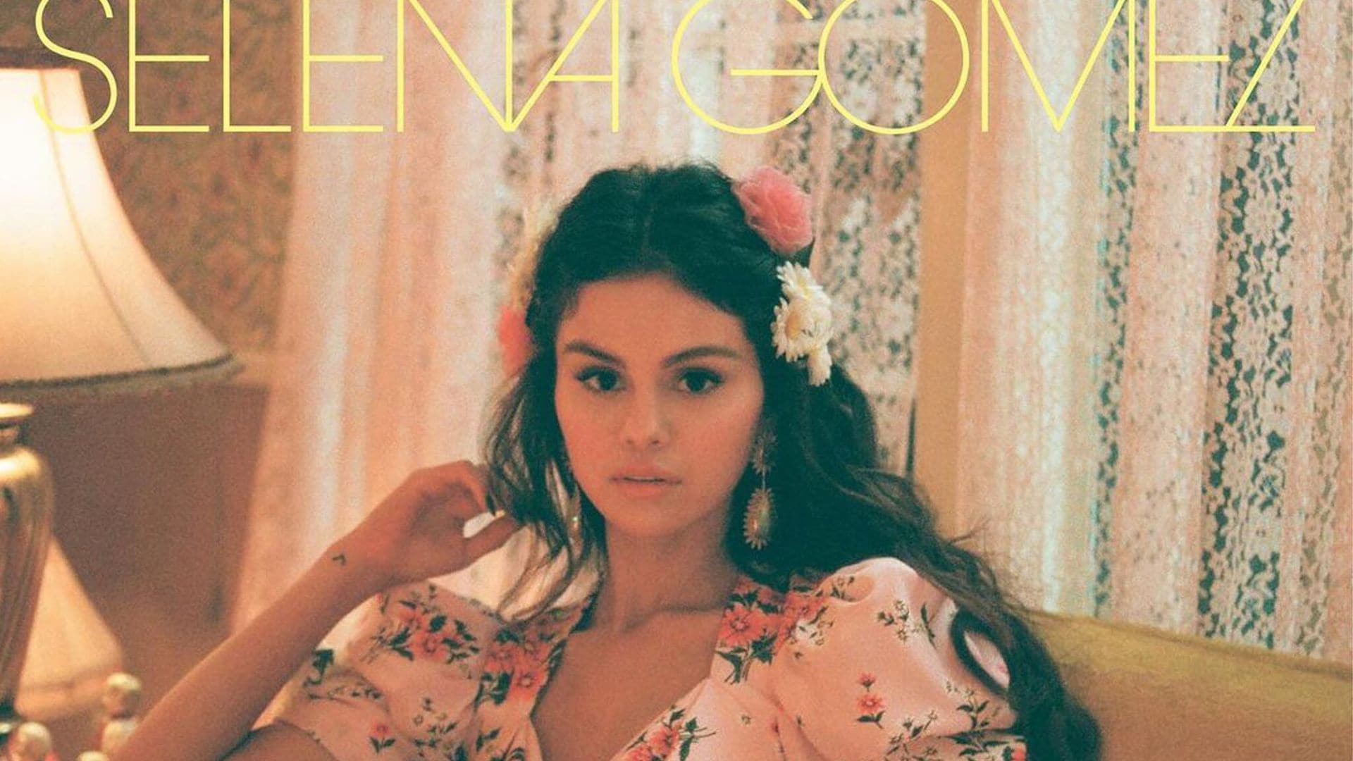 Selena Gomez De Una Vez Cover Art. Sitting on couch in pink floral dress with illuminated heart.