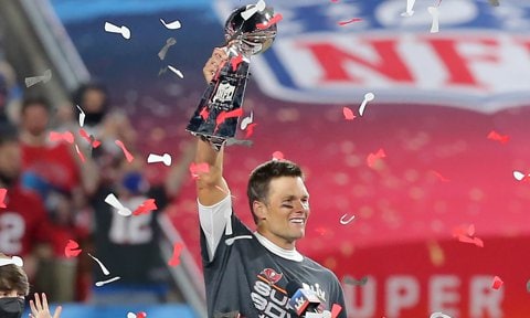 Super Bowl MVP Tom Brady (12) of the Buccaneers hoists the Lombardi Trophy after the Super Bowl LV.