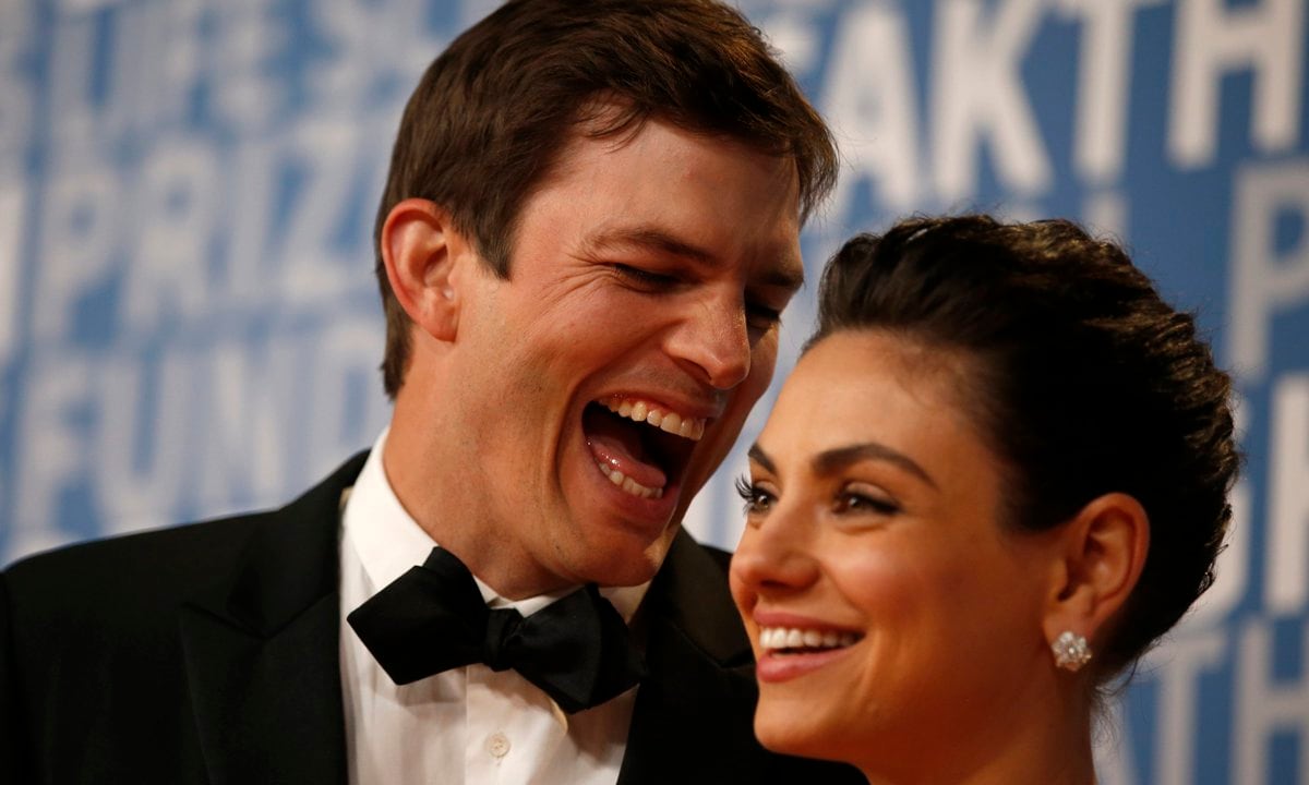 Actor Ashton Kutcher laughs with his wife actress Mila Kunis while posing for pictures on the red carpet for the 6th annual 2018 Breakthrough Prizes at Moffett Federal Airfield, Hangar One in Mountain View, Calif., on Sunday, Dec. 3, 2017. (Nhat V. Meyer/