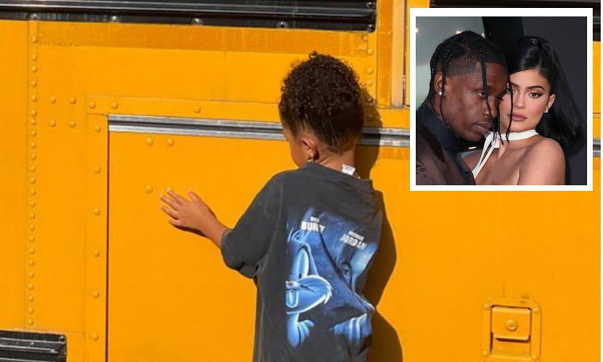 Stormi Webster pretends to ride in a yellow school bus