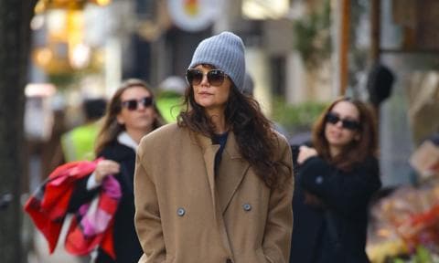 Katie Holmes bundles up in a long tan coat and a gray beanie as she runs a few errands in New York