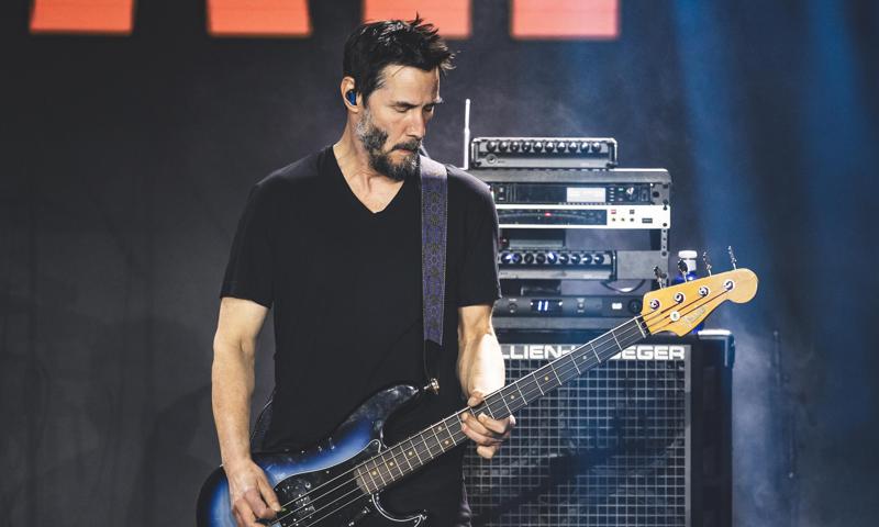 Keanu Reeves shows off skills on the bass at Madrid concert